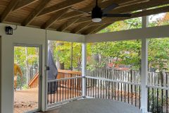 Wolf Amberwood decking and Trex Select white rail with black balusters.