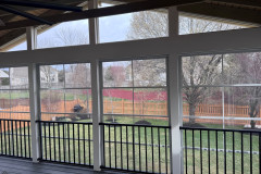 Eze-Breeze windows and black Westbury Tuscany aluminum railing set inside the windows.