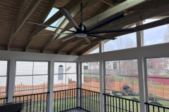 Open rafter ceiling with skylights and ceiling fan.