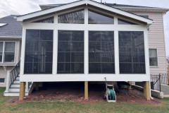 20' x 14' porch with Eze-Breeze windows and side landing with stairs.