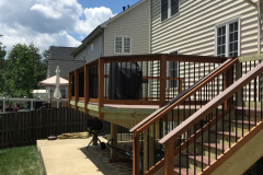Deck with Wolf Rosewood decking, wood railing with Deckorator balusters - Bristow, VA
