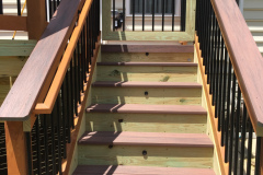 Deck with Wolf Rosewood decking, wood railing with Deckorator balusters - Bristow, VA