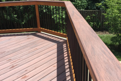 Deck with Wolf Rosewood decking, wood railing with Deckorator balusters - Bristow, VA