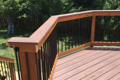 Deck with Wolf Rosewood decking, wood railing with Deckorator balusters - Bristow, VA