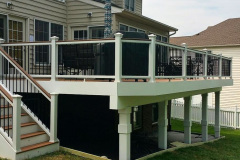 Decking in Trex Tiki Torch. Railing in white Trex Transcends with Tree House cocktail rail and black balusters in Ashburn, VA