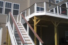 Screen porch and deck in Wolf Amberwood and Rosewood decking. Trex Transcends railing - Woodbridge, VA